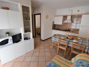 a kitchen and dining room with a table and chairs at Apartment Mediterraneo-3 by Interhome in Rosapineta