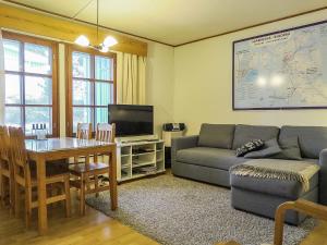 a living room with a couch and a table at Holiday Home Saariselän väärtin kammi 2 by Interhome in Saariselka