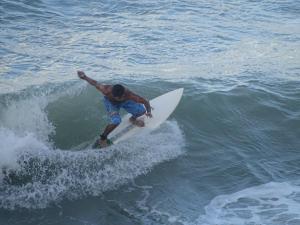a man riding a wave on a surfboard in the ocean at Hostel Terra Viva in Pipa