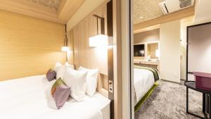 Hotel Musse Kyoto Shijo Kawaramachi Meitetsu客房内的一张或多张床位
