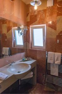 a bathroom with a sink and a mirror at Lulu Boutique Hotel in Żebbuġ