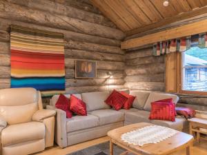 a living room with a couch and a table at Holiday Home Tokkapirtti 3 by Interhome in Sirkka