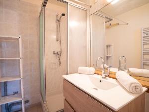 a bathroom with a sink and a shower at Apartment Soyouz Vanguard-80 by Interhome in Le Corbier
