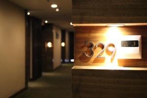 a lightswitch with the number on a wall at Poly Hotel, Guangzhou in Guangzhou +2 photos