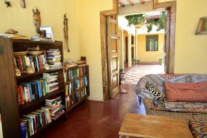 a living room with a book shelf filled with books at Sawa Sawa Beach House in Msambweni