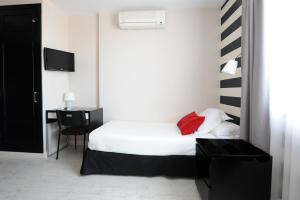 Een bed of bedden in een kamer bij Hotel Domus