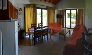 a kitchen and living room with a table and chairs at Parisis Villas in Troulos