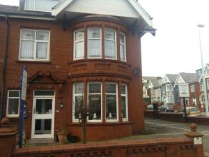 a red brick building with a large window at The Beaucliffe Hotel in Blackpool