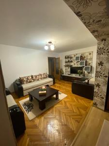 a living room with a couch and a table at Friend's House in Piteşti