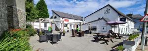 a group of tables and benches in front of a building at The Lamb and Flag Inn in Rhayader