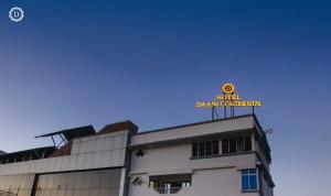 a building with a neon sign on top of it at Hotel Daani Continental in Imphal