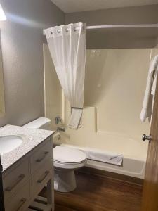 a bathroom with a toilet and a sink and a tub at I M Hotel by Timberlake in Grand Rapids
