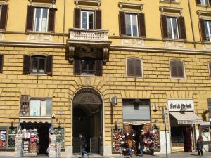 a yellow brick building with a balcony on top of it at Sweet Dreams Roma in Rome +31 photos