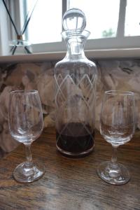 three wine glasses sitting on a table with a decanter at The Tickled Trout Inn Bilton-in-Ainsty in York