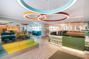 un vestíbulo de una oficina con muebles coloridos en ibis Styles Athens Routes en Athens