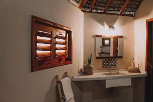 a bathroom with a sink and a mirror at Vila Prana in Barra Grande