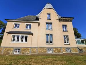 a large house with a pointed roof at Le Manoir de la Rulette 20P well-ness BBQ Jardin terrasse ping pong salle de jeux in Tintigny