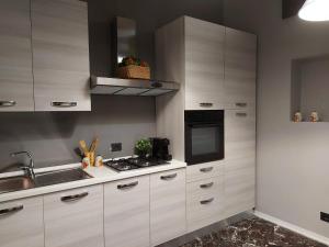 a kitchen with white cabinets and a stove at Bnbook-Villa Molinari in Milan