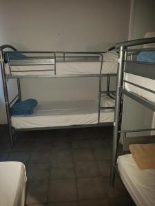 a room with three bunk beds in a room at HOTEL SYLVABELLE in Marseille