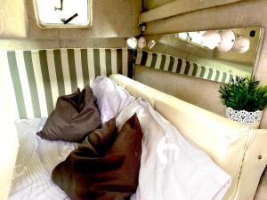 a bed with two pillows on it in a room at Barco Pita - Amarilla Marina in San Miguel de Abona