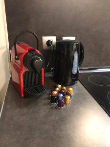 a coffee maker and a toaster on a kitchen counter at la licorne { T2 tous confort} centre ville in Pont-Audemer +2 photos