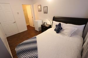 a bedroom with a bed with a black and white comforter at Illu B&B in Cambridge Bay