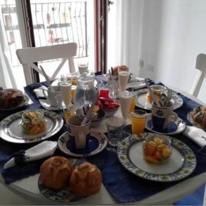 a table with plates of food on top of it at Casa Blu Cobalto in Maiori