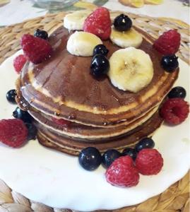 a stack of pancakes with fruit on a plate at Casa Blu Cobalto in Maiori