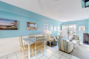 a dining room and living room with blue walls at Sea Pines Village - 5 Sea Pines Village in Bethany Beach