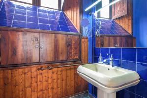 a bathroom with a sink and blue tiled walls at Casa Tradicional Canaria in Garachico +20 photos