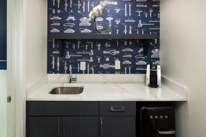 a kitchen with a sink and a blue and white wallpaper at Hotel Indigo Boston Garden, an IHG Hotel in Boston