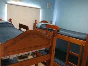 two bunk beds in a room with blue walls at Atlantis Park in Mar de Ajó
