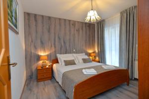 Postel nebo postele na pokoji v ubytování Apartments Elvis 1299