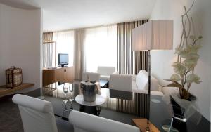 a living room with white furniture and a table at Grand Hotel Admiral Palace in Chianciano Terme