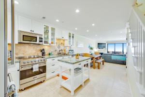a kitchen with white cabinets and a living room at Seascape Sanctuary in Aptos