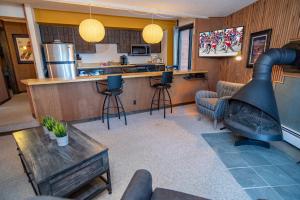 a living room with a kitchen and a bar at Peak 8 Village Getaway Condo: On Shuttle Route in Breckenridge