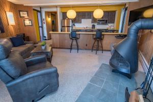 a living room with a couch and a fire place at Peak 8 Village Getaway Condo: On Shuttle Route in Breckenridge