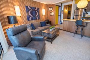 a living room with a couch and a table at Peak 8 Village Getaway Condo: On Shuttle Route in Breckenridge