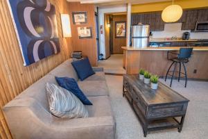 a living room with a couch and a table at Peak 8 Village Getaway Condo: On Shuttle Route in Breckenridge