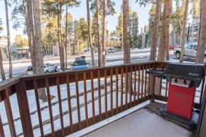 a grill on a deck with trees at Peak 8 Village Getaway Condo: On Shuttle Route in Breckenridge +18 photos