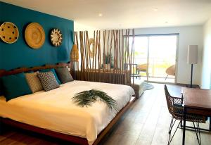 a bedroom with a large bed and a table and chairs at Orient Beach Hotel in Orient Bay
