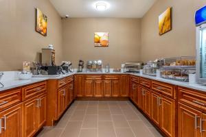 a large kitchen with wooden cabinets and aasteryasteryasteryasteryasteryasteryasteryastery at Comfort Inn in Brewster