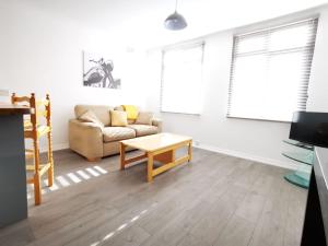 a living room with a couch and a coffee table at High Street Flats in Broadstairs