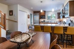 a kitchen with a table and some chairs and a counter at Cedars 38 Townhome Ski In Ski Out in Breckenridge