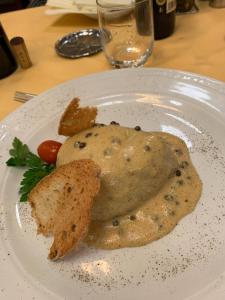 a white plate with a piece of food on it at Hotel Massimo d'Azeglio in Montecatini Terme