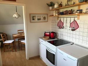 a kitchen with a sink and a stove top oven at Ferienwohnung Heikendorf in Heikendorf