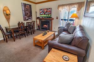 a living room with a couch and a fireplace at Mountainside 343B in Frisco