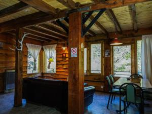 a dining room in a log cabin with a table and chairs at Rio Mel Lodge in Villa Meliquina +22 photos