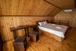a room with a bed in a wooden cabin at Спортохота in Cherkasy +41 photos