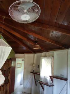 a room with a wooden ceiling with a light at Hibiscus Valley Inn in Marigot